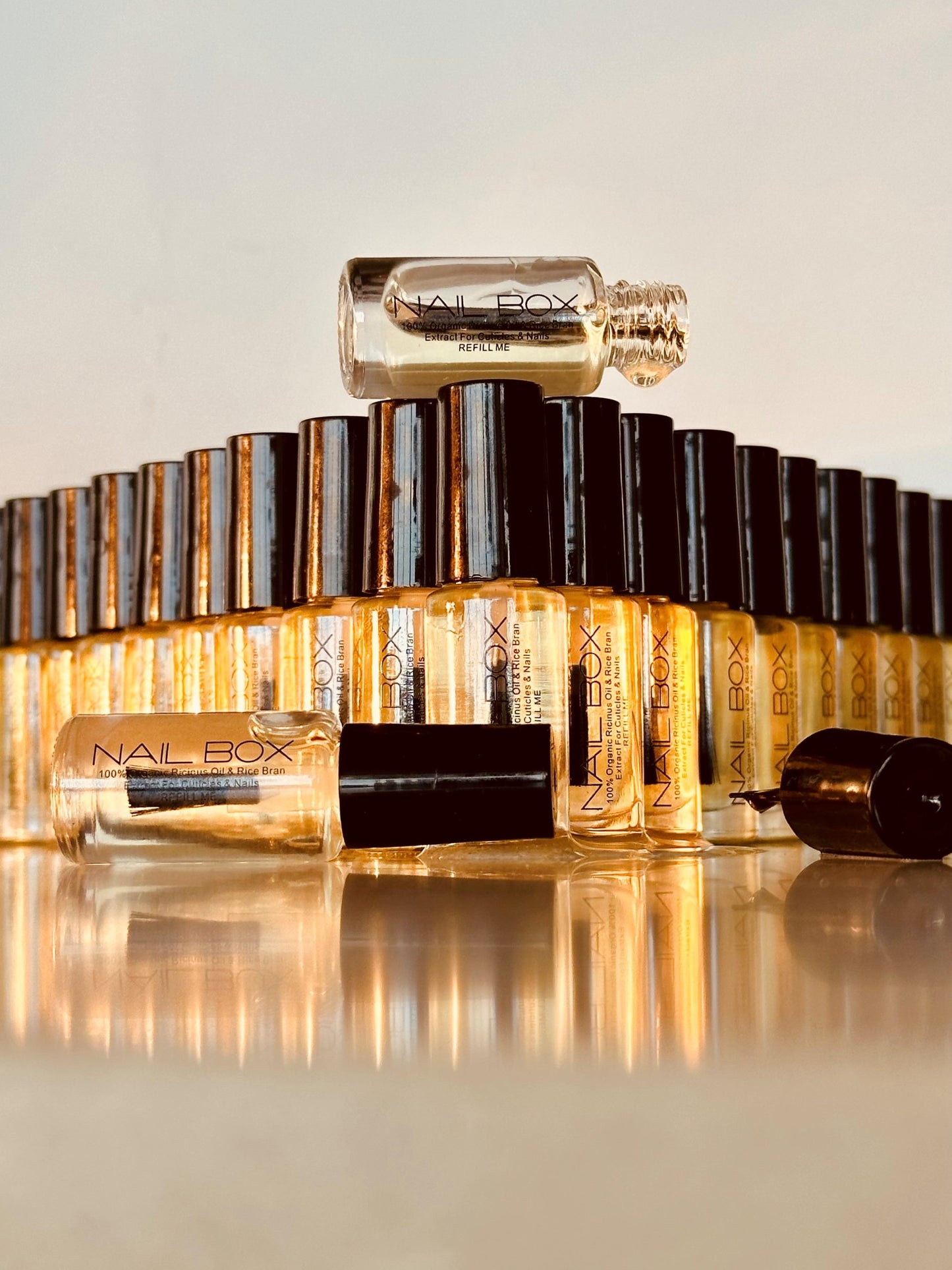 A display of Nail Box Cuticle and Nail Oil with one on its side spilling out on the counter