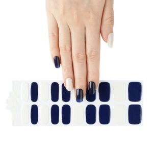 Female hand touching a Blue and white with sparkles over the white semi cured gel nail sticker kit sold by Nail Box