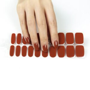 a felame hand touching a red/brown semi cured gel nail sticker kit sold by Nail Box